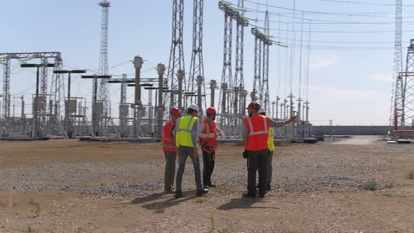 Group of Engineers Checking Power Station Construction Site alt