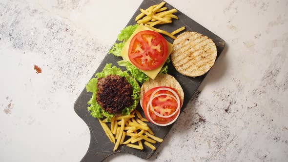 Two Tasty Grilled Home Made Burgers with Beef, Tomato, Onion and Lettuce alt