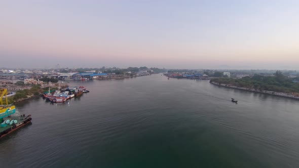 Fishing Boats Docked On The Lakeshore In Rayong Port, Thailand On A Sunrise - Aerial Shot alt