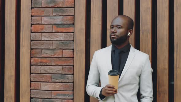 Portrait of African American Businessman with Coffee on Street alt