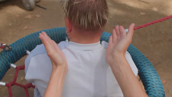 Social worker doing massage to disabled person. Congenital amputations. Close up alt