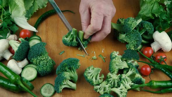 Close Up Knife Cutting Fresh Green Broccoli