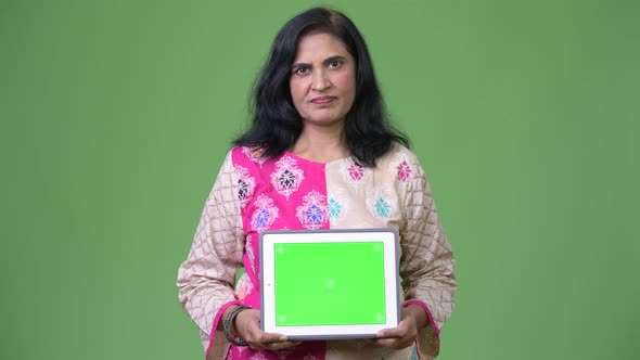 Mature Beautiful Indian Woman Showing Digital Tablet alt