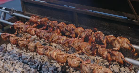 Grilled squab, Street night market in Thailand 