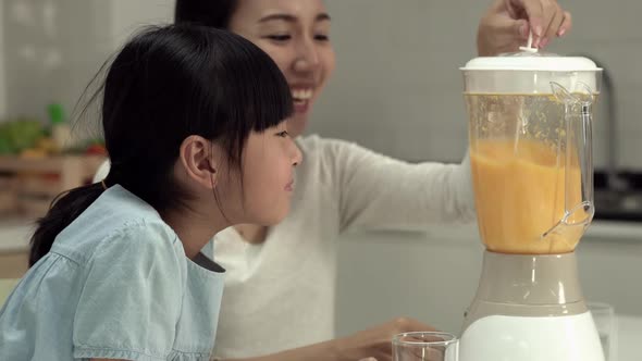 Woman and little girl with electric blender alt