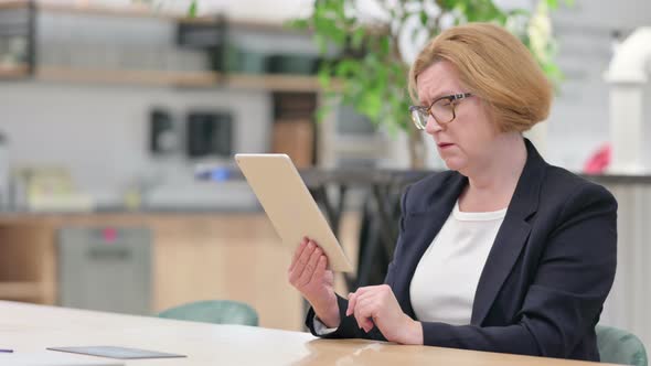 Upset Businesswoman Reacting To Loss on Tablet alt