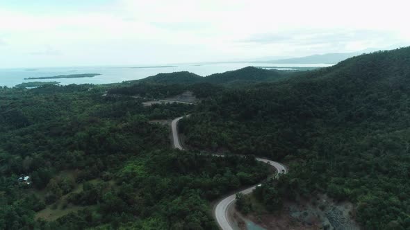 Aerial View of Countryside Road Passing Through the Lush Greenery and Foliage Tropical Rain Forest alt