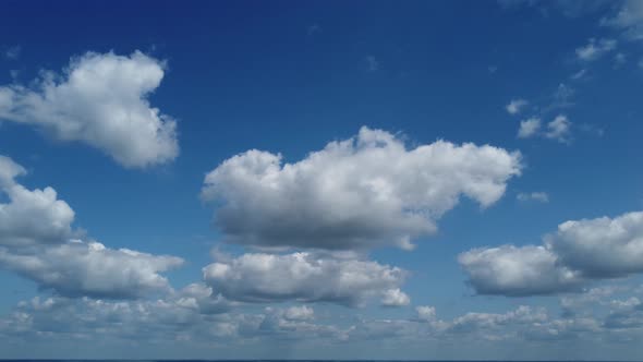 4k. Aerial view. The drone flies over foggy and fluffy clouds. Blue sky sun. Abstract aerial nature 