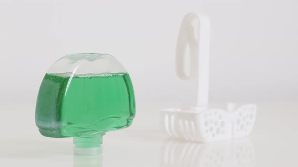 Transparent green gel in  plastic toilet bowl freshener 4K footage