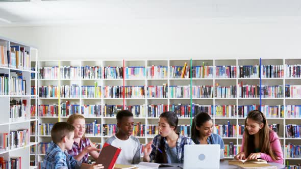 Schoolkids studying in library 4k alt