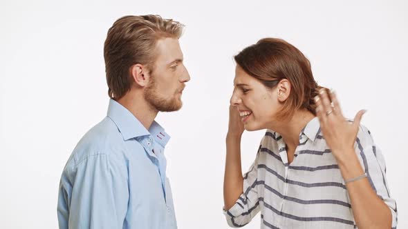 Young Caucasian Couple Arguing and Disagree with Each Other on White Background in Slowmotion alt