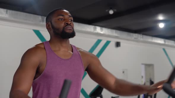 African American Bearded Man Workout on Velosimulator in the Gym alt