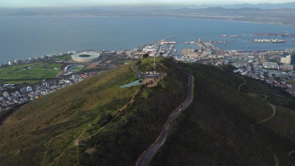 Drone shot of Signal Hill in Cape Town - drone is circling around Signal Hill, facing Green Point an alt