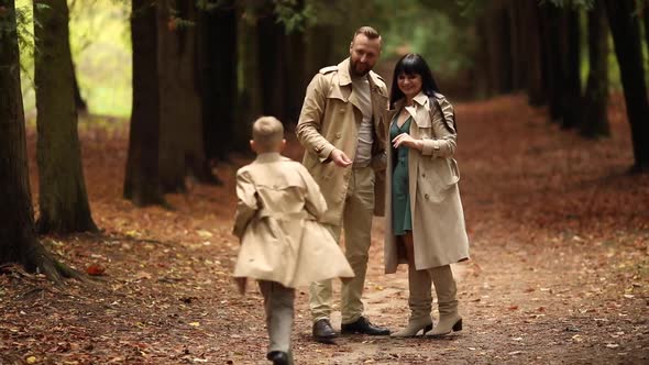 A Happy Family is Walking in the Park