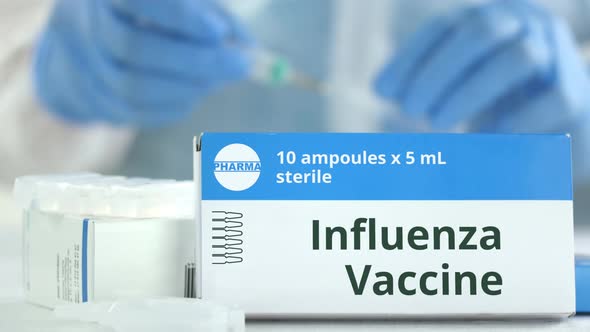 Box with Influenza Vaccine on the Table alt