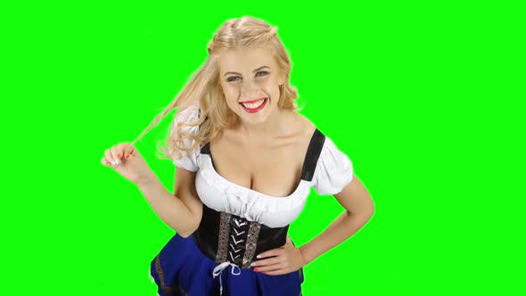 Bavarian Woman Flirty Winds To Finger a Strand of Hair and Smiling. Green Screen alt