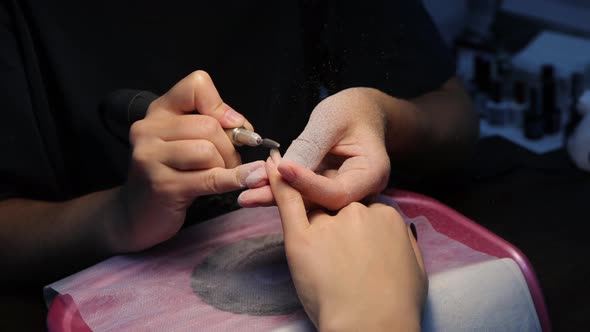 Anonymous Beautician Doing Manicure to Female Client