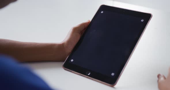 African american businesswoman sitting at desk having video call using tablet with copy space alt