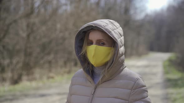 Woman in Yellow Protective Mask. Quarantine.