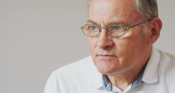 Closeup Portrait of a Serious Grayhaired Senior Man in Glasses alt
