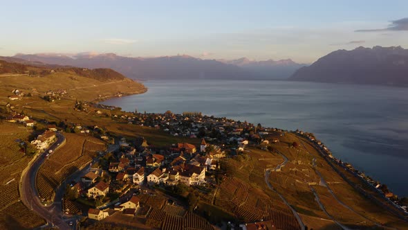 Aerial orbit high over Grandvaux and Lavaux vineyardLake Léman and the Alps in the backgroundOrang alt