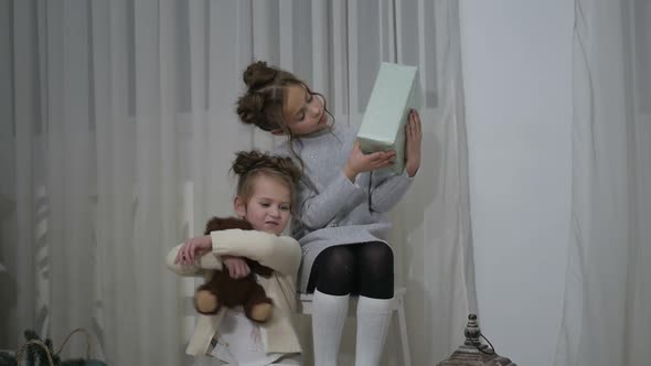 Adorable little children rejoice in the holy Christmas. Merry Christmas and Happy Holidays. alt