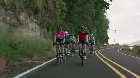 Tracking shot of a group of cyclists on country road.  Fully released for commercial use.