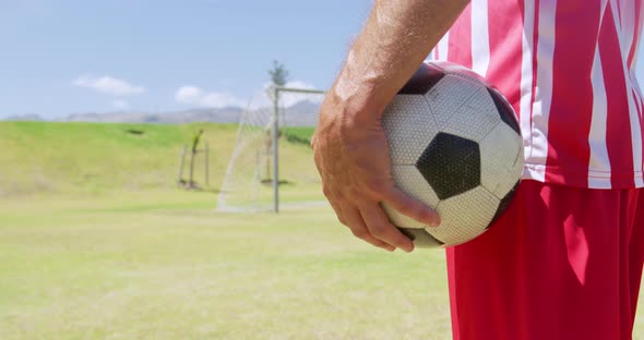 Soccer player holding ball alt