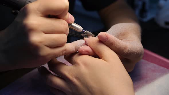 Anonymous Beautician Doing Manicure to Female Client