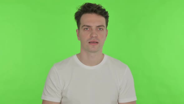 Stop Gesture By Young Man on Green Background alt