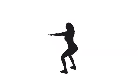 Silhouette Of Young Slender Sporty Woman Practicing Squats Exercises