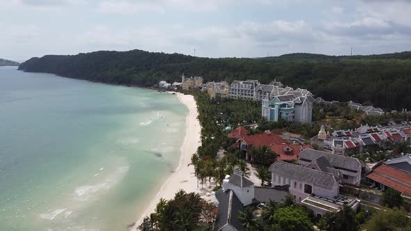 Aerial View of the Luxury Blue Ocean Hotel on an Island with White Sand Palm Trees Along the Beach