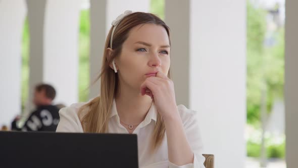 Portrait of Serious Focused Woman Working on Laptop Computer Looking Away RED alt