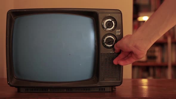 Male Hand Turning On A Retro TV Green Screen. alt