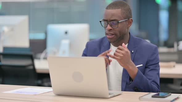 Young African Businessman Talking on Video Call on Laptop alt