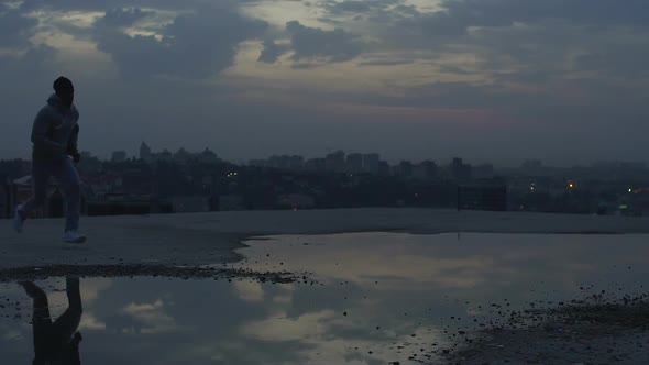Male Traceur Running on Roof Learning New Tricks and Movements, Street Parkour alt