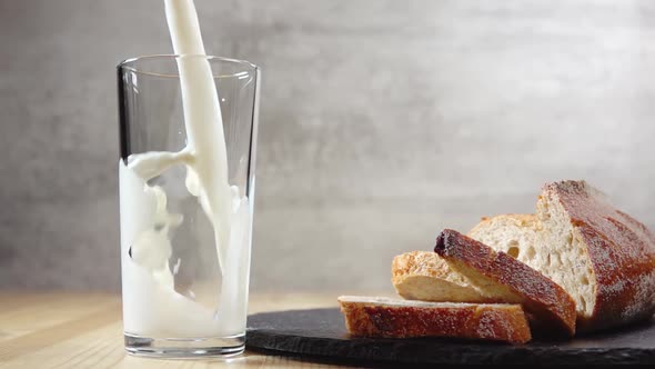 Fresh Pieces of Bread and Milk, Which are Poured Into a Glass