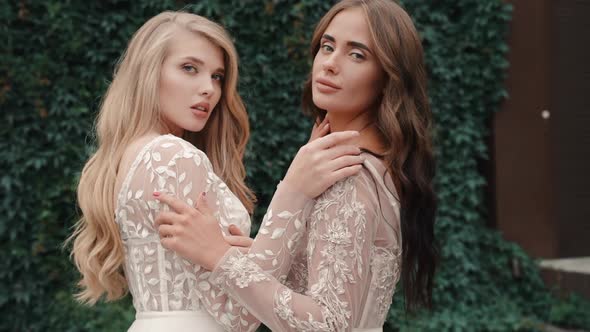 Two Models Posing at Bridal Photo Shoot for Fashion Magazine Advert Outdoor