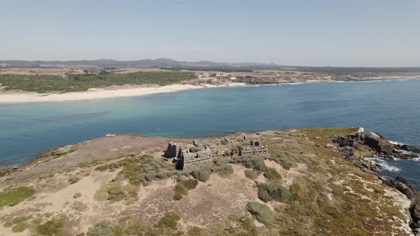 Ruins fortress on Pessegueiro island, Porto Covo in Portugal. Aerial forward