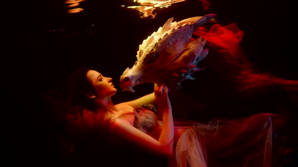 Woman and Dragon in Depth of Ocean or Sea Lady is Holding Mythological Hydra Beast alt
