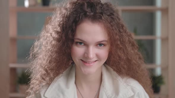 Modern Young Girl with Curly Hair 2025 Years Old Looks at the Camera