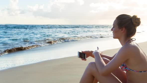 Young woman on beach alt