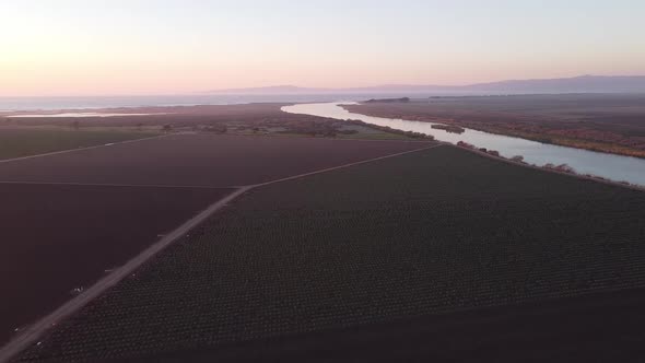 Salinas River turn near Castroville surrounded by vast agriculture farmland, aerial drone view alt