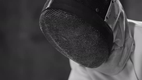 Close Up of Male Fencer Sitting in White Protective Helmet alt