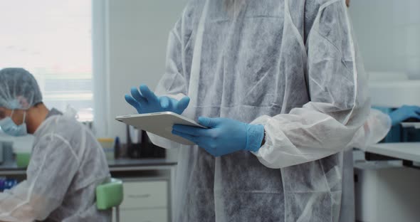 A Team of Laboratory Technicians Work in a Modern Wellequipped Laboratory alt