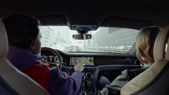 The driver behind the wheel of the car looks at the map.