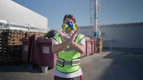 Confident Caucasian Man in Respirator and Uniform Crossing Hands Shaking Head No Looking at Camera alt