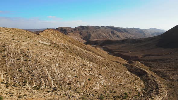 A drone shot of a crater of Israel. Ramon Crater is the largest crater- geological erosion land form alt
