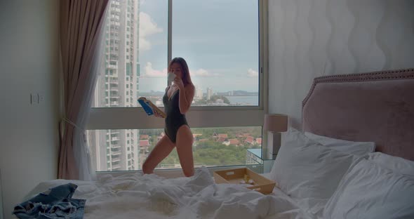 Woman Posing with Book and Coffee at Luxury Hotel By the Window alt