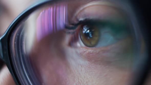 Woman with Glasses Eyes Looking at the Tablet Surfing the Internet Closeup alt